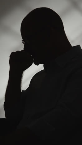 Vertical-Video-Silhouette-Of-Depressed-Mature-Man-Struggling-With-Mental-Health-In-Slow-Motion